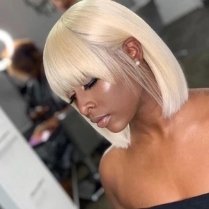 Detail of platinum blonde bob wig with straight hair and neat fringe on model