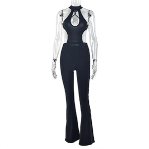 Detail view of the halter neck cutout and slim fit flared legs of this black jumpsuit
