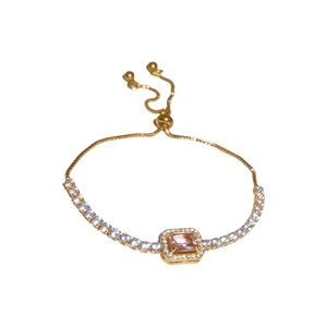 Elegant adjustable gold bracelet with a rectangular pink stone and halo cubic zirconia