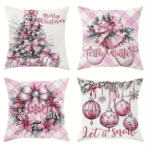 Detail view of 4 pink and white Christmas pillow covers with holiday patterns and greetings