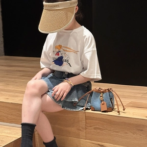 Girls denim and brown leather drawstring bucket bag styled with casual summer outfit