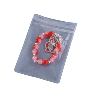 Transparent PVC self-sealing jewelry bag with pink bead bracelet and bear pendant