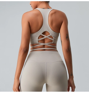 Macro detail of beige sports bra featuring criss-cross back straps and matte texture