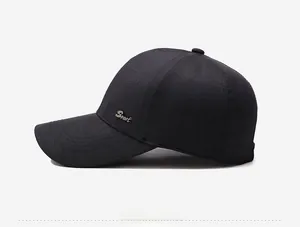 Detail of black baseball cap with triple stitching on brim and metal Sport side plaque
