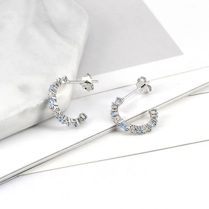 Close-up of S925 silver C-shape earrings set with sparkling light blue cubic zirconia
