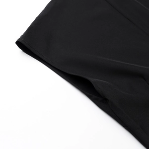 Detailed close-up of precise stitching and pocket seam on black sleeveless dress fabric