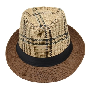 Detail of a beige and brown straw fedora hat with a black and beige plaid crown and band