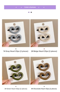 Detail of four Morandi heart hair clips in grey, beige, green, and chocolate colors