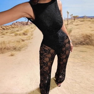 Sexy black backless lace sleeveless jumpsuit for women in a desert outdoor setting