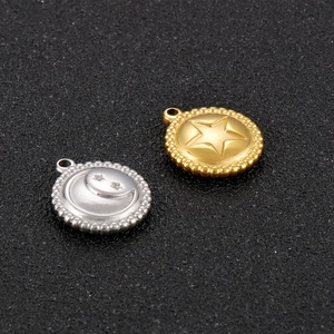 Close-up of gold and silver stainless steel celestial pendants with star and moon motifs