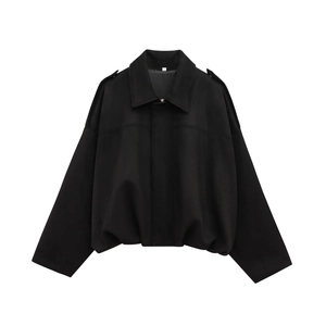 Detailed view of black oversized bomber jacket with wool-like texture and shoulder epaulettes