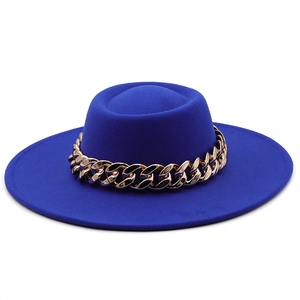 Detail of royal blue wool fedora hat featuring a chunky gold metal chain decoration