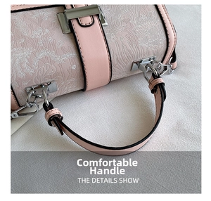 Detailed close-up of pink jacquard handbag featuring floral embroidery and silver hardware