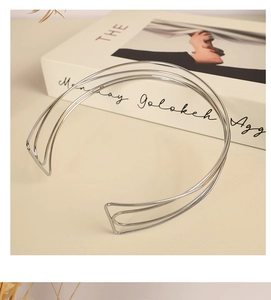 Detailed view of silver minimalist multi-layer metal choker necklace on elegant background