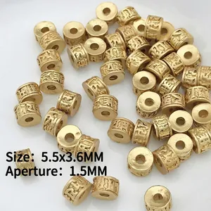 Macro shot of gold cylinder spacer beads with relief patterns for DIY jewelry making