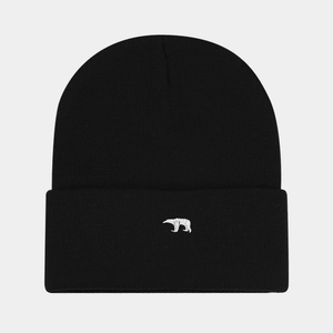 Close-up of white polar bear embroidery on a black ribbed knit beanie for winter
