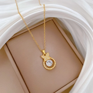 Detailed close-up of a golden butterfly ring necklace with sparkling pavé zircons