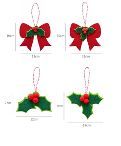 Detail view of 4-pack felt Christmas ornaments with red berries and holly leaf patterns