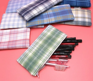 Detail view of colorful plaid canvas pencil cases showing large storage capacity
