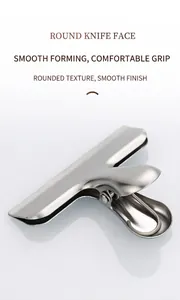 Macro shot of polished stainless steel food clip with wide mouth and brushed metal finish