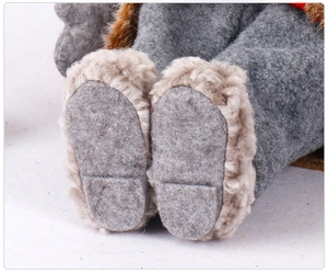Close-up of plush gnome feet with gray felt material and brown faux fur texture