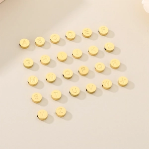 Macro shot of gold stainless steel alphabet beads A-Z for DIY jewelry making