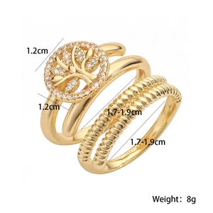 Detailed view of 3-piece gold plated ring set featuring tree of life and zircon accents