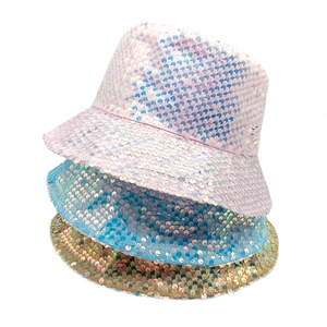 Macro shot of three stacked colorful sequined bucket hats showing texture and shimmer