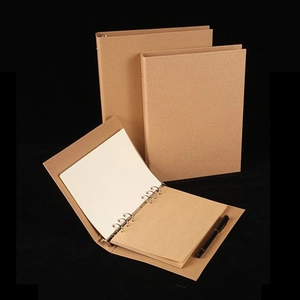 Vintage Kraft paper A4 A5 binder notebook with metal rings and black pen on black background