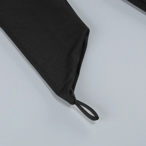Detail of dark style black dress showing high-density elastic fabric and cuff hook design