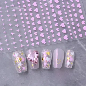 Detail of pink heart nail stickers with gold frame accents and aurora sequins