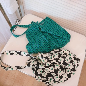 Detail of green geometric and floral cotton canvas tote bags with large capacity straps