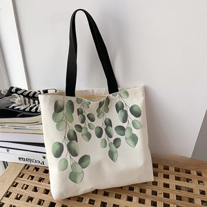 Detail of eco-friendly canvas tote bag featuring green eucalyptus leaf print pattern