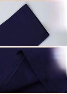 Detail view of the ribbed cuffs and hem stitching on a navy blue cotton dinosaur t-shirt