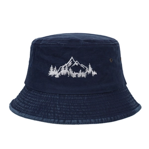 Close-up of navy blue cotton fishing hat with white mountain and forest embroidery