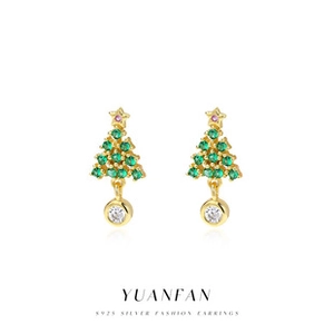 Macro shot of S925 silver Christmas tree earrings with green gemstones and a clear drop