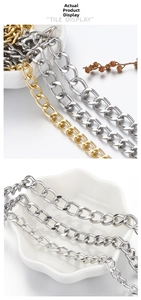 Close-up of gold and silver flat Cuban link chains displayed on a minimalist white bowl