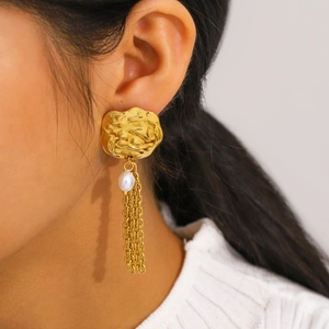 Elegant gold petal earrings with white pearl and long tassel chain on a model