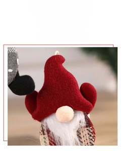 Macro shot of plush Christmas gnome ornaments showing textured felt and plaid fabric detail