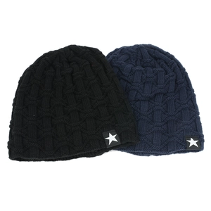 Detail of winter beanie hats with star logo label and textured knit pattern