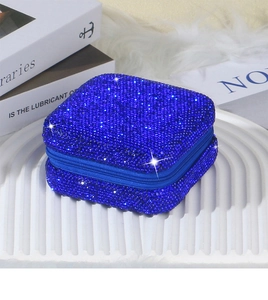 Macro detail of royal blue rhinestone square jewelry storage box with zipper closure