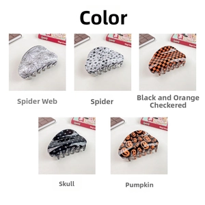Detail view of five Halloween hair claw clips with spider web, skull and pumpkin patterns