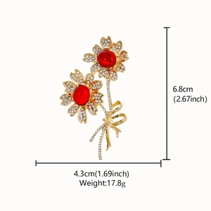 Detail view of rose brooch with red stones and crystals including product dimensions