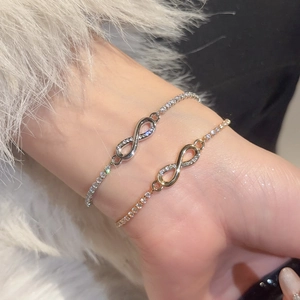 Detail of infinity tennis bracelets with cubic zirconia in silver and gold plating