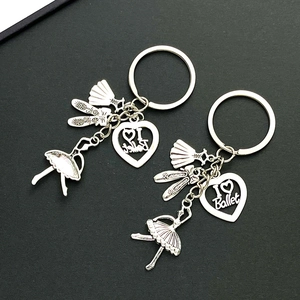 Close-up of two silver ballet keychains with dancer and engraved heart charms