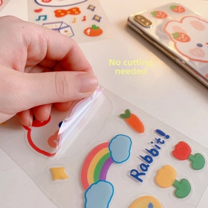 Detail showing waterproof cartoon rabbit stickers being peeled for phone case decoration