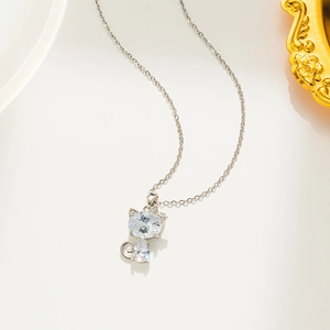 Close-up of a sparkling silver cat necklace with micro-pave crystals on white background