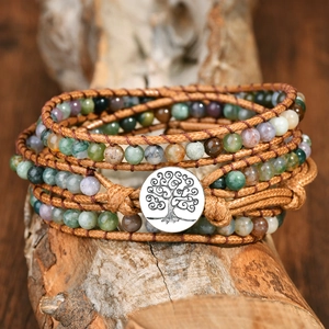 Handmade Indian Agate wrap bracelet with Tree of Life metal clasp on a natural wooden branch