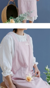 Detail of pink cotton linen apron with wide straps and functional front pocket