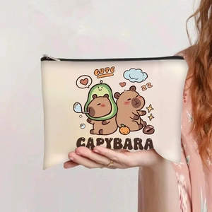 Close-up of canvas makeup bag featuring cute cartoon capybara prints and black zipper